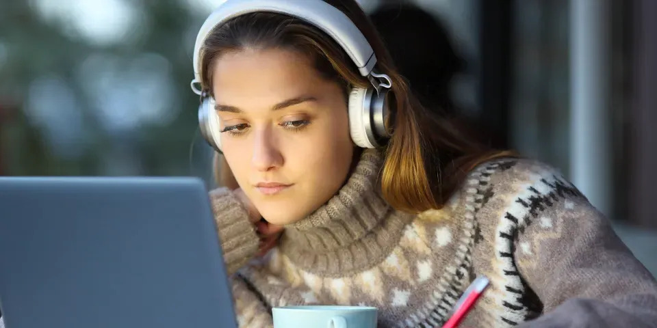 Student e-learning in a coffee shop in winter